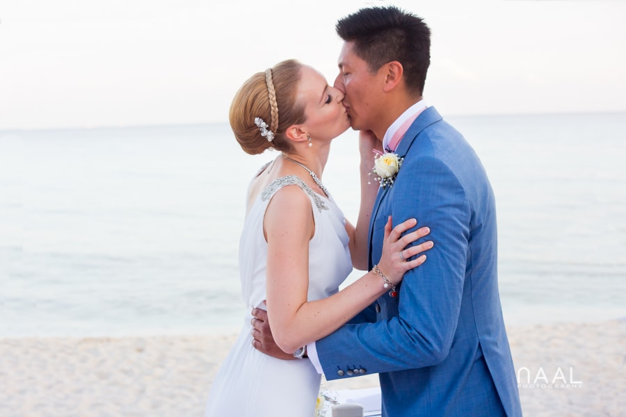 first kiss bride and groom at Blue Venado beach Club by Naal Wedding Photography